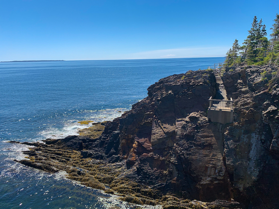 View of the cliffs with a manmade stairway trail and the ocean in the Ovens Natural Park.