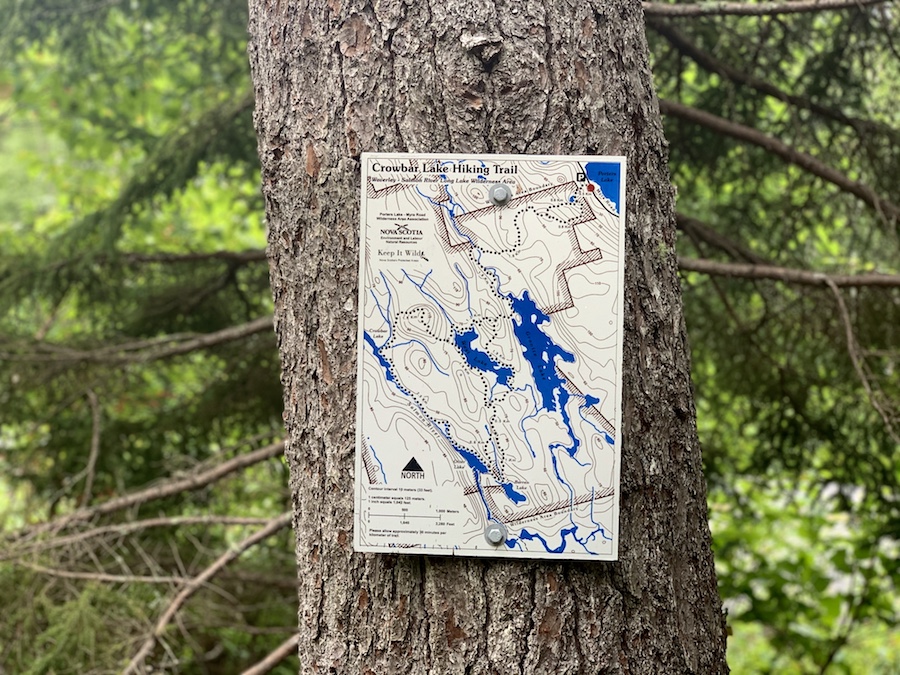 Crowbar Lake trail map on a tree. 
