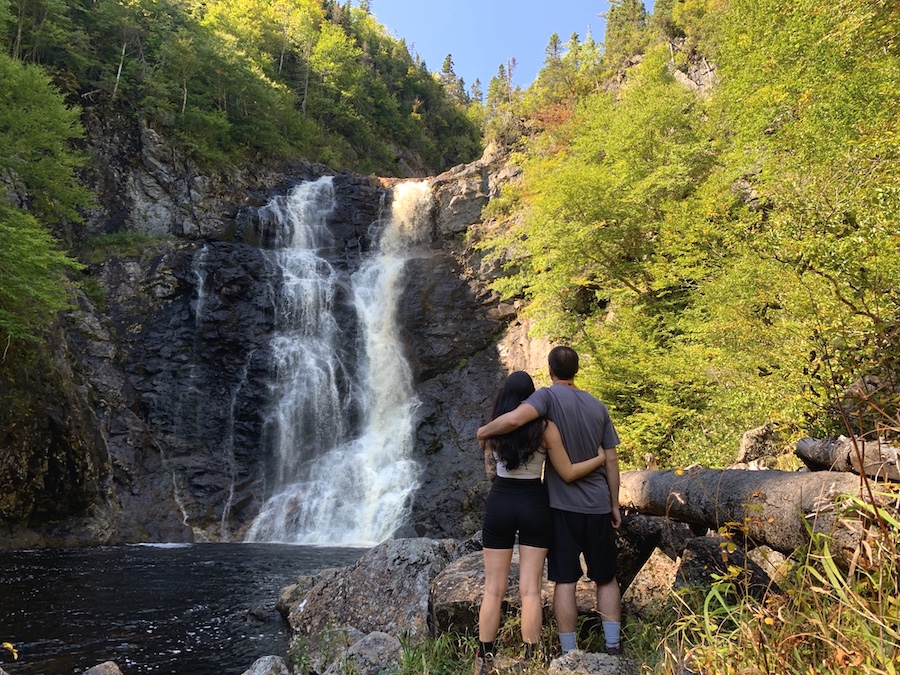 Arthur and Julia standing in front of North River Falls waterfall after a long yet beautiful hike.