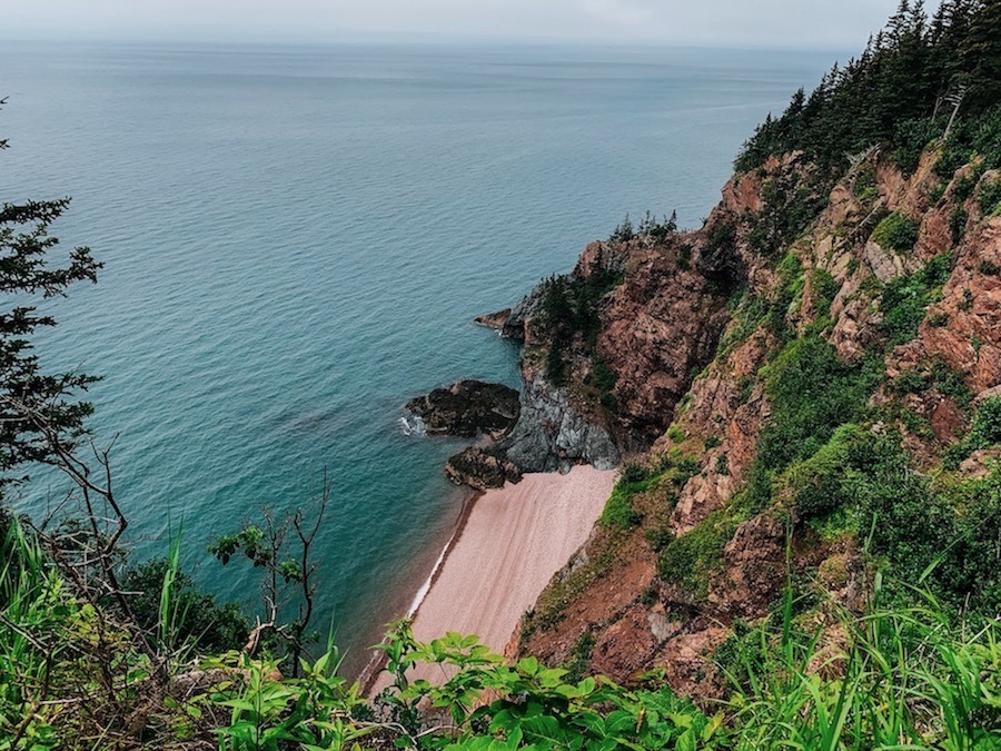 Cliffside view with a small isolated beach and the Bay of Fundy on the Cape Chignecto trail. 