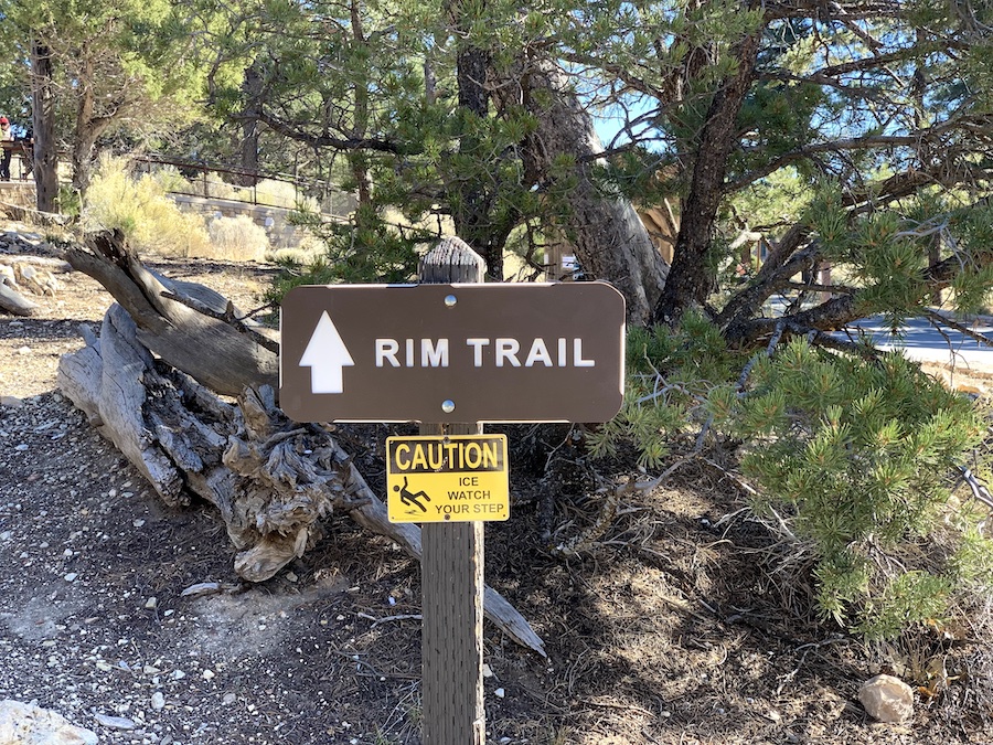 Rim Trail sign with arrow pointing which way to go. 