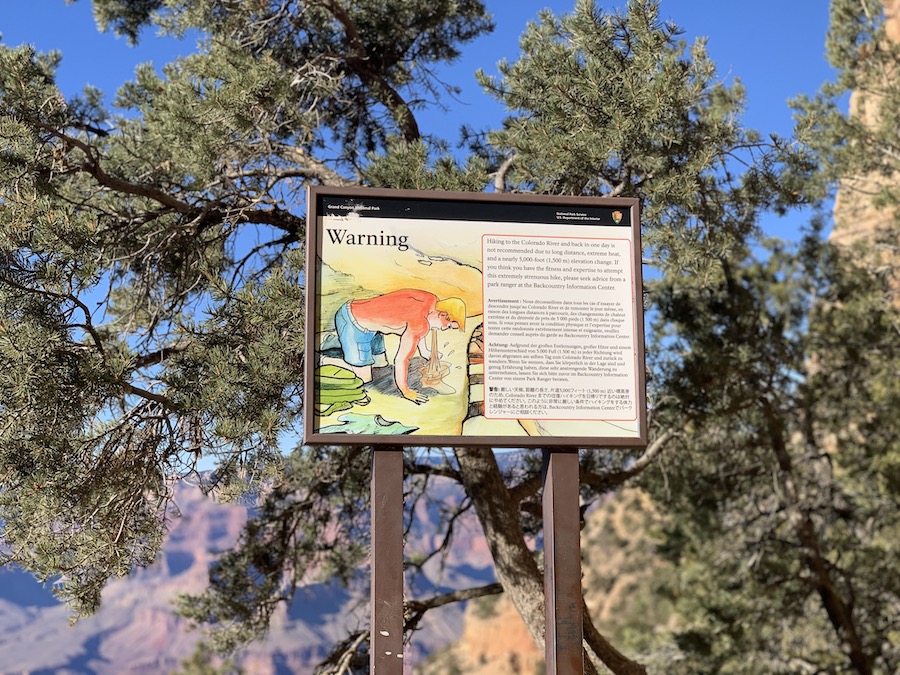 Warning signs about fatigue and dehydration along the South Kaibab Trail.