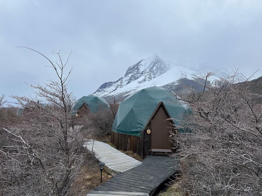 Two of the EcoCamp Patagonia domes with the mountains in the background.
