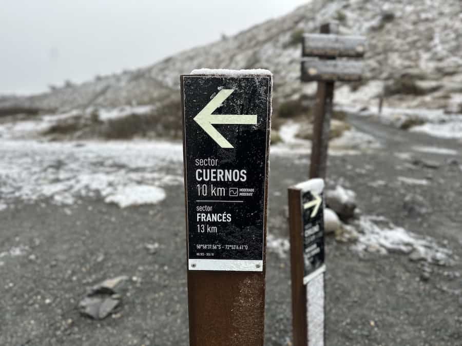 Trail sign indicating 10 km to Los Cuernos trail. 