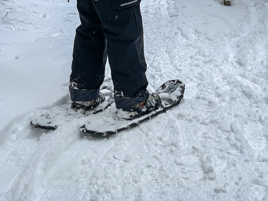 Walking in snowshoes, showing how to snowshoe for beginners.