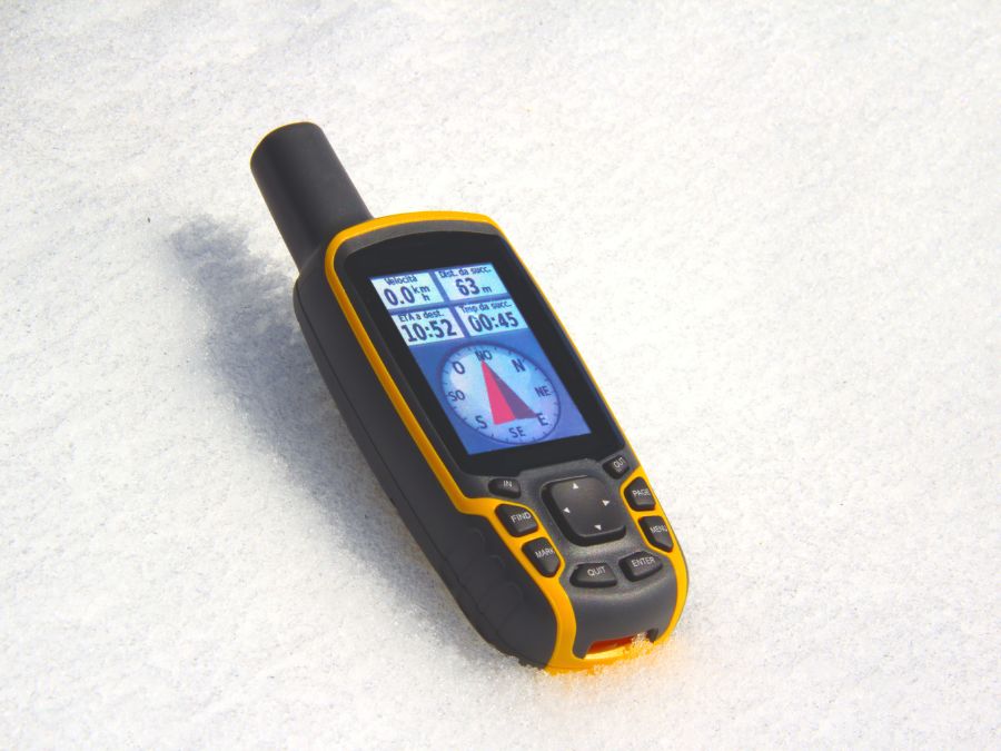 A GPS device in the snow used for winter hiking. 