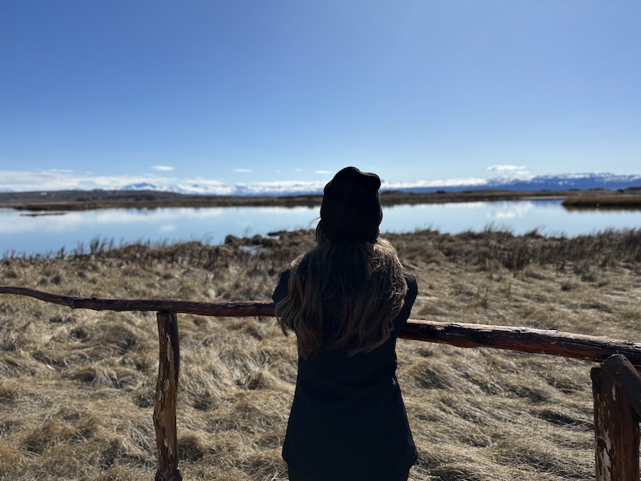 hiker practicing Leave No Trace by observing nature at a distance.